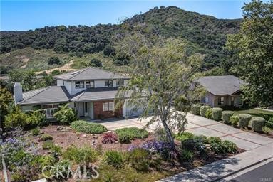 Perched on a peaceful cul-de-sac in San Luis Obispo’s coveted Irish Hills, this spacious 5-bedroom, 4-bath home offers the perfect blend of comfort, flexibility, and stunning natural beauty. The main residence boasts bright, open living spaces filled with natural light, a modernized kitchen ideal for gathering, and seamless indoor-outdoor flow to an expansive deck where panoramic mountain views set the scene for entertaining or quiet evenings at home. A rare highlight of this property is the fully permitted, 760 sq. ft. ADU with its own private entrance—perfect for extended family, visiting guests, or generating strong rental income. With multiple living areas, a cozy fireplace, and a versatile office/den, the home adapts easily to a variety of lifestyles. Situated on a generous lot surrounded by trails and open space, yet just minutes from downtown SLO, Cal Poly, and top-rated schools, this property captures the best of Central Coast living. Whether you’re seeking a multi-generational retreat or a smart investment, 967 Capistrano Court delivers both.