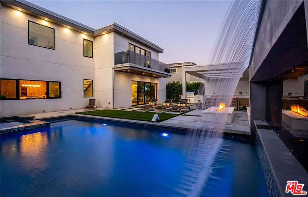 Built in 2019, this Modern two-story gem, located in the desired Chandler Estates neighborhood, offers a bright and open concept floor plan, high ceilings throughout, state-of-the- art appliances and expensive fixtures that truly make this home unparalleled to the rest! This home offers 4 beautiful en-suites, including the main floor office/bedroom, a formal dining area for entertaining, a spacious chef-inspired kitchen with Miele appliances which includes a built-in coffee bar, 48-inch stove, Sub-zero fridge/ freezer towers, and wine/beverage storage fridge. Make your way to the warm and inviting living room which is custom marble inspired and wraps around the entertainment center beautifully, showcasing the built-in flat screen and modern and sleek gas fireplace. Make your way outside to the back patio/backyard with the Fleetwood sliding pocket doors that offer the true indoor/outdoor experience. Enjoy the covered backyard patio with fully appointed BBQ area, firepit, and more! The breathtaking waterfall is resort-style built and oozes serenity as it makes its way down into the saltwater system pool and spa. With the latest in high tech conveniences, enjoy the control 4 home automation system, Central Vacuum System, Security Camera System and built-in surround sound speakers!