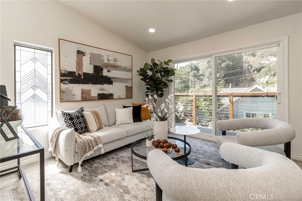 Tucked into the canyons of Sierra Madre, this updated home offers the perfect balance of retreat and convenience. Built in 1984 and refreshed in recent years—with a newer roof, remodeled kitchen and primary bath, updated patio doors, and fresh paint inside and out. The two-story layout is both comfortable and practical. The lower level includes two bedrooms, a full bath, and a laundry area. Upstairs, vaulted ceilings open up the main living space, where the kitchen, dining, and living room flow together easily. A fireplace anchors the room, and sliding doors lead out to a balcony where you can enjoy fresh air or look up at the stars. The primary suite feels generous, with a walk-in closet and a full ensuite bath.
Life here is as much about the setting as the home itself. The canyon is quiet and walkable, with footbridges and the sound of a nearby creek adding to the charm. Local favorites like Mary’s Market, Sierra Madre Playhouse, Baldwin Gallery, and Nano Café are just minutes away, while nearby hiking trails make it easy to enjoy the outdoors. And when you need to get back to the city, the 210 Freeway is just a couple of miles away. Families will also appreciate the highly rated Sierra Madre Elementary and Middle School.