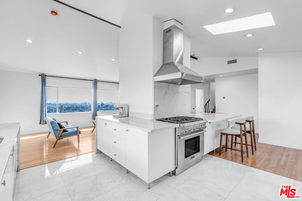 Perched in the Los Feliz Hills, this sun-filled upper-unit duplex feels calm and open the moment you step inside. Light moves through every corner, and the views stretch across Los Angeles, giving the home a soft hillside glow throughout the day. The main living area is spacious and easy to settle into, with picture windows framing the skyline and a fireplace that anchors the room. The kitchen sits just off the living space, bright and airy with sleek stainless steel appliances, including a gas range, fridge, hood, and dishwasher. It is perfect for slow mornings with coffee, catching up on emails, or cooking dinner with friends while the sun sets outside. We can already picture your first housewarming. Down the hall are three comfortable bedrooms, each filled with light and a sense of calm at the end of a long day. The primary bedroom includes its own bathroom for extra privacy and ease. Both bathrooms have been beautifully updated with standing showers, new vanities, and modern finishes, keeping everything feeling fresh and simple. Outside, a shared outdoor area with a pergola and firepit gives you a spot to unwind, read, or catch up with friends under the stars. The owner plans to refresh the outdoor space soon, adding an extra touch to what already feels like a true hillside retreat. Last, but not least, the home comes equipped with a washer and dryer in the living room, and a private two-car garage offers parking and plenty of storage. This home has an easy rhythm, bright, open, and peaceful, with views that remind you why Los Feliz living never gets old.