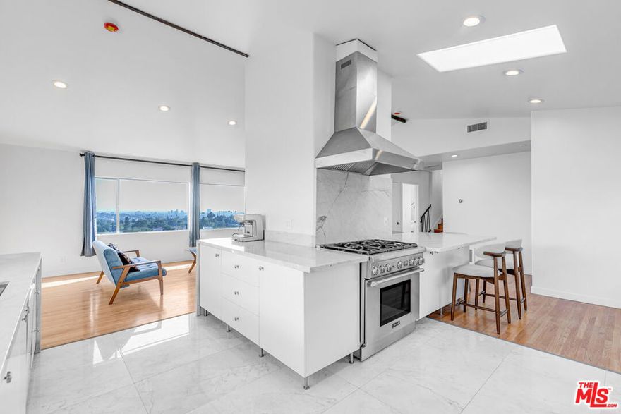 Perched in the Los Feliz Hills, this sun-filled upper-unit duplex feels calm and open the moment you step inside. Light moves through every corner, and the views stretch across Los Angeles, giving the home a soft hillside glow throughout the day. The main living area is spacious and easy to settle into, with picture windows framing the skyline and a fireplace that anchors the room. The kitchen sits just off the living space, bright and airy with sleek stainless steel appliances, including a gas range, fridge, hood, and dishwasher. It is perfect for slow mornings with coffee, catching up on emails, or cooking dinner with friends while the sun sets outside. We can already picture your first housewarming. Down the hall are three comfortable bedrooms, each filled with light and a sense of calm at the end of a long day. The primary bedroom includes its own bathroom for extra privacy and ease. Both bathrooms have been beautifully updated with standing showers, new vanities, and modern finishes, keeping everything feeling fresh and simple. Outside, a shared outdoor area with a pergola and firepit gives you a spot to unwind, read, or catch up with friends under the stars. The owner plans to refresh the outdoor space soon, adding an extra touch to what already feels like a true hillside retreat. Last, but not least, the home comes equipped with a washer and dryer in the living room, and a private two-car garage offers parking and plenty of storage. This home has an easy rhythm, bright, open, and peaceful, with views that remind you why Los Feliz living never gets old.