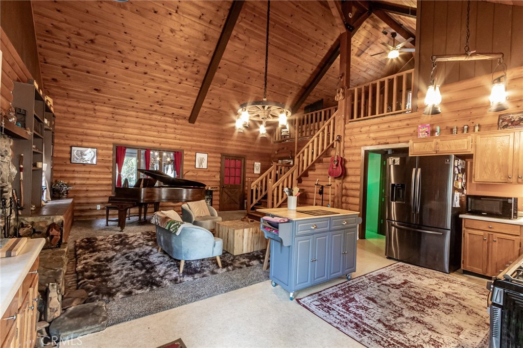 Tucked away in the peaceful mountain community of Forest Falls, this charming home offers a rustic log cabin feel with modern comfort and incredible versatility. Just 30 minutes from Redlands, you’ll find yourself surrounded by towering trees, serene views, and access to hiking trails and a nearby waterfall. Although it may appear modest from the front, this spacious three-story home sits on nearly a quarter-acre lot and surprises with its generous layout. Soaring ceilings with exposed wood beams and an abundance of natural light create a warm, airy feel throughout the main living areas. A striking lantern chandelier offers the perfect rustic focal point to the large great room, which features a cozy fireplace and blends seamlessly with the open-concept kitchen. French doors lead to a spacious deck overlooking the forest—perfect for enjoying your morning coffee or mountain evenings. The primary bedroom is conveniently located on the main level, along with a versatile bonus room ideal as a sunroom, game room, or creative space. Upstairs, a charming loft with a full bath offers additional sleeping or office. Downstairs, with its own separate entrance, you’ll find a huge living area warmed by a wood-burning stove, plus another full bathroom—an ideal setup for guests, extended family, or a potential rental opportunity. Whether you're looking for a full-time home, a weekend getaway, or an income-generating Airbnb mountain escape, this nature-lover’s paradise is ready to welcome you. Schedule your private tour today!