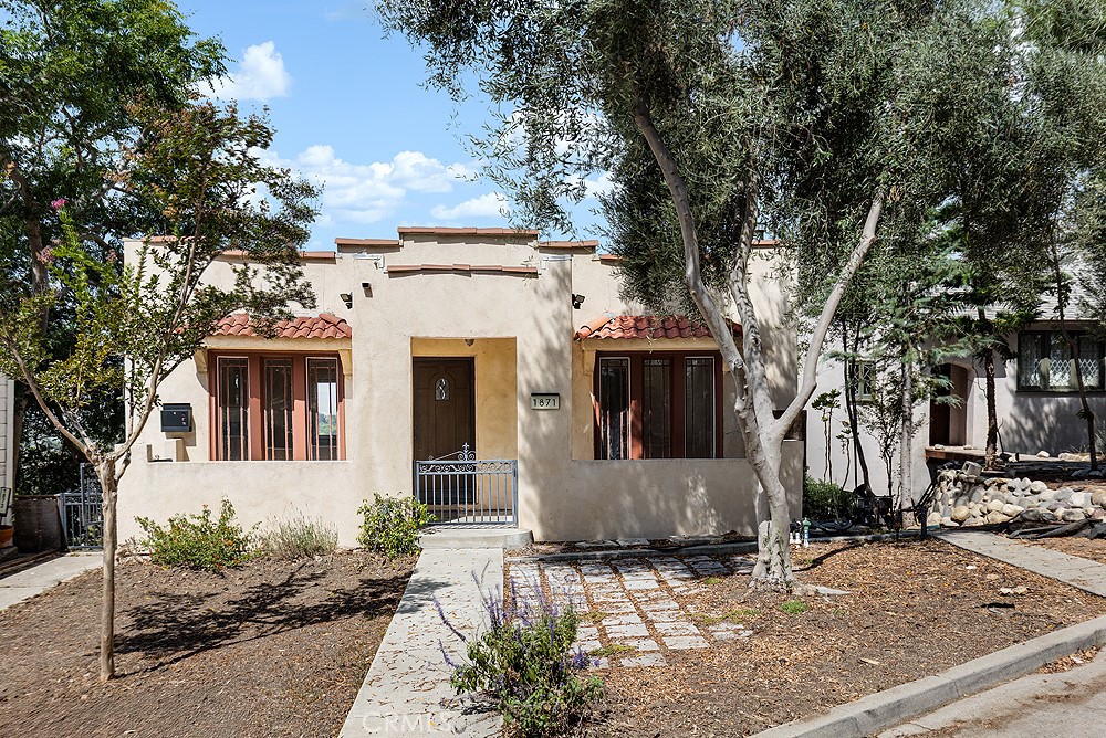 This charming vintage duplex is nestled on the hilltops of Echo Park, offering breathtaking city-light views and serene wilderness vistas. This section of Park Drive is quite unique in that there are no homes across the street, and the property's front yard looks at trees and nature—offering a tranquil ambiance. The property features a classic Spanish-bungalow style, with 1,487 square feet of living space spread across two units. The upper unit, a spacious 875 square feet, features one bedroom, one bathroom, dining room, and stunning views. It also has fresh interior paint, including the kitchen cabinets. The lower unit, at 612 square feet, also offers one bedroom, one bathroom, and a cozy ambiance. Each unit features their own in-unit laundry closets, central heating, and separate patio spaces. The detached one-car garage and driveway provide convenient storage and parking for the upstairs unit. Seize the opportunity to own this unique property in a coveted location.