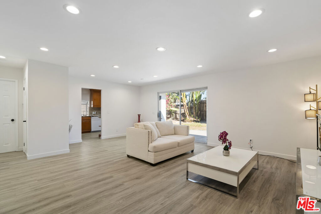 Welcome to this beautifully remodeled 3-bedroom, 2-bathroom home located on a quiet street near the highly regarded Hamlin Charter Academy. The open-concept living area is filled with natural light and opens directly to a private backyard through sliding glass doors. The spacious primary suite offers a large closet, en-suite bathroom, and abundant natural light. Two additional bedrooms are located on the opposite side of the home, along with a remodeled guest bathroom. The kitchen features granite countertops, modern appliances, and direct backyard access. Additional upgrades include new flooring, recessed lighting, and fresh interior paint throughout. Mature trees and flower beds create a charming outdoor space perfect for relaxation or entertaining. This move-in ready home is waiting for you.