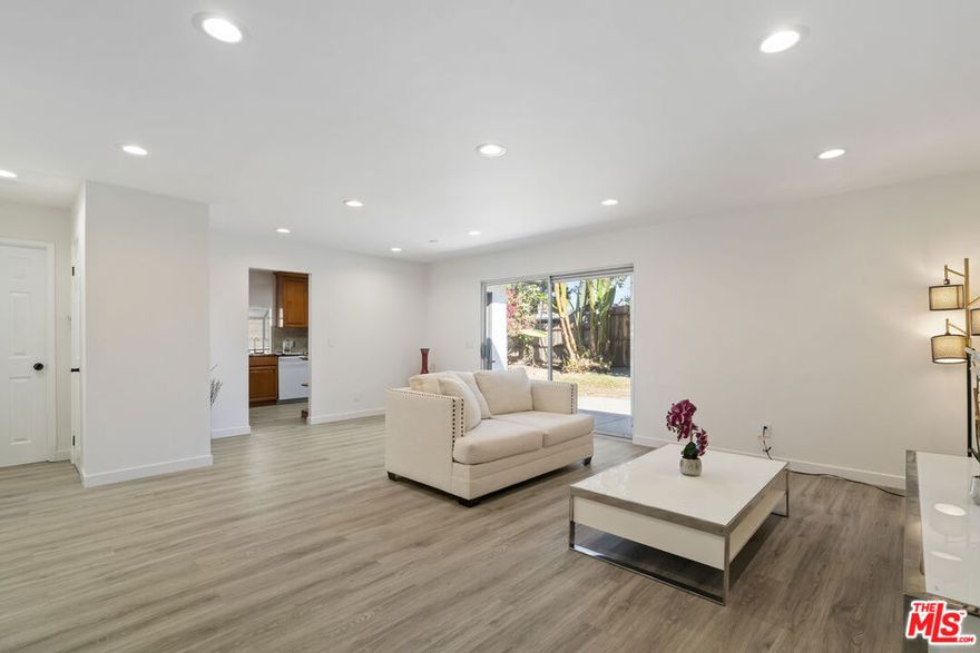 Welcome to this beautifully remodeled 3-bedroom, 2-bathroom home located on a quiet street near the highly regarded Hamlin Charter Academy. The open-concept living area is filled with natural light and opens directly to a private backyard through sliding glass doors. The spacious primary suite offers a large closet, en-suite bathroom, and abundant natural light. Two additional bedrooms are located on the opposite side of the home, along with a remodeled guest bathroom. The kitchen features granite countertops, modern appliances, and direct backyard access. Additional upgrades include new flooring, recessed lighting, and fresh interior paint throughout. Mature trees and flower beds create a charming outdoor space perfect for relaxation or entertaining. This move-in ready home is waiting for you.