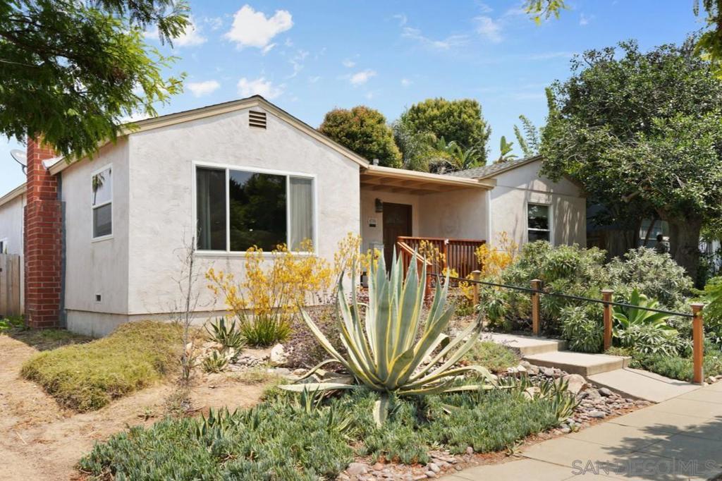 Tucked into the heart of Point Loma Heights, this stylish single-level home is a true coastal haven. Remodeled throughout with an open floorplan and newer hardwood floors, it’s ready to move right in. The show-stopping 2023 custom kitchen features Taj Mahal quartzite countertops and backsplash, an island that seats five, stainless steel appliances, and easy indoor-outdoor flow to the backyard—perfect for entertaining under the San Diego sun. The private primary suite is tucked away at the rear of the home and features a beautifully remodeled bathroom. Other upgrades include dual pane windows, a 2023 HVAC system (yes, it has AIR CONDITIONING), and low-maintenance landscaping on a drip system—including your own vegetable garden out back. The oversized garage off the alley is a rare find—already set up with a workshop and space for a car, it could be reconfigured to fit more vehicles, toys, or even your next project. All this, just a short stroll into Ocean Beach.
