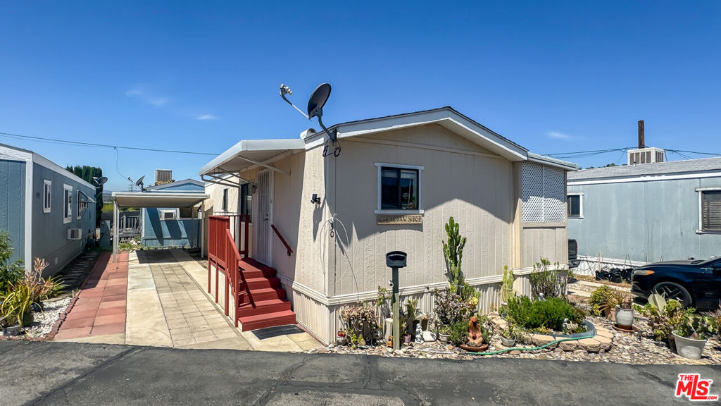 Charming and thoughtfully maintained, this updated single-wide home offers a perfect blend of comfort and style in the welcoming Sierra Mobile Home Park. A lovely drought tolerate garden greets you as you approach the home. As you enter, there is a living room and kitchen that has solid maple cabinetry, crisp white tile countertops, all appliances, and warm wood laminate flooring tying the space together. The comfortable one bedroom has ample storage and is right next to the one bathroom. The washer and dryer are right nearby in the hallway. An inviting 6'x26' sunroom addition provides extra living space. A large storage shed at the rear of the property adds even more functionality and a covered parking spot for convenience. Located in a desirable 55+ community known for its quiet streets, welcoming neighbors, and easy access to shopping, dining, and local conveniences, this home offers low-maintenance living in a truly charming setting.