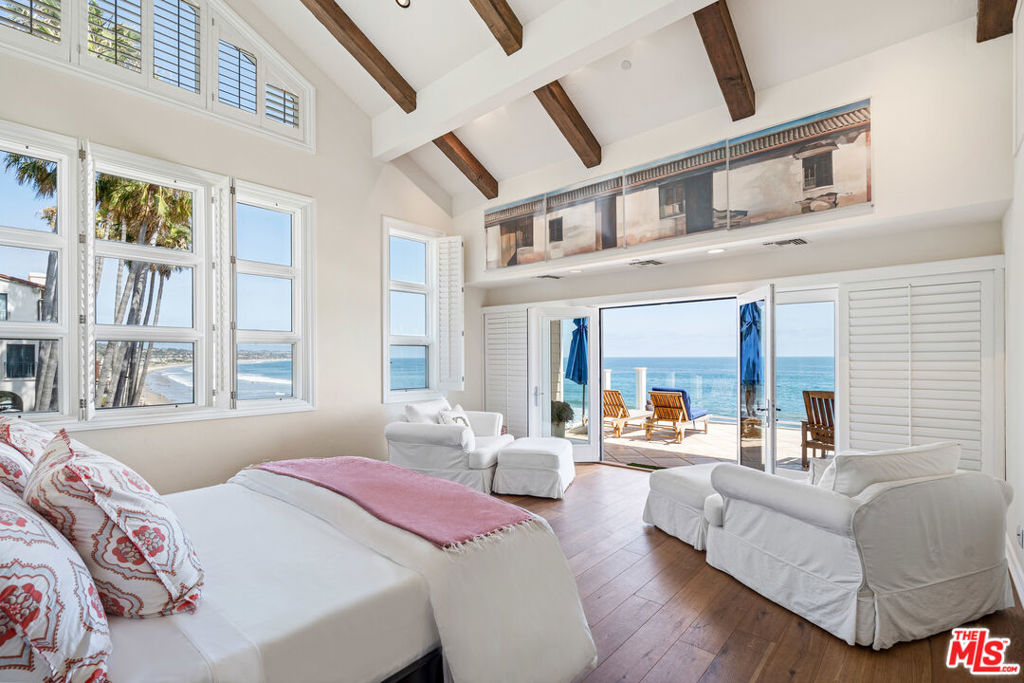 This ultimate beachfront retreat is set on the only sandy beach in Malibu where the gentle slope creates exceptionally approachable waves breaking far off from shore. The view from this home is one of the best in Southern California and can be appreciated from the approx. 2500 square foot great room living area or the extraordinarily spacious beachfront deck adjoining the living area ( or the expansive master bedroom deck) which showcases the wide sandy beach, Lechuza Point with pristine cove and rock formations, and a coveted surf break The tastefully remodeled kitchen offers substantial storage and amenities not found in most beach homes. Lounge in the 1400+ square foot oceanfront three-room master suite with vaulted ceilings, private fireplace retreat, spa-style bath area, large deck, gym area, and multiple closets. Two more spacious ocean-view suites are featured in the main residence, with three detached guest suites. This is also one of the rare beach homes in Malibu that is connected to a sewer treatment facility, not septic system. This property has excellent investment potential as a seasonal rental, and additional features include an elevator, courtyard spa, three-car garage, and off-street parking. REST4Plans measured the home at 8,072 total square feet under roof, making it one of the largest homes on Broad Beach on a single 50 foot lot. Rare and remarkable.