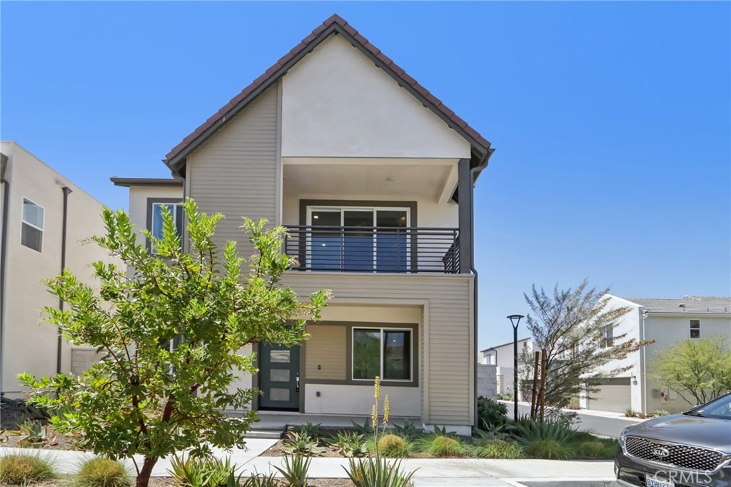 Welcome to this stunning, nearly new 3-bedroom, 3.5-bathroom home in the highly sought-after FivePoint community—where modern living meets effortless comfort. Boasting over 2,400 square feet of thoughtfully designed space, this home features an open floor plan flooded with natural light, creating a bright and inviting atmosphere throughout. Step into the expansive great room where luxury vinyl plank flooring, high ceilings, and oversized windows enhance the airy ambiance. The seamless flow between the living area, dining space, and chef-inspired kitchen makes entertaining and everyday living a breeze. The kitchen is a true showpiece, equipped with a large center island, sleek quartz countertops, stainless steel appliances, and an oversized custom pantry with built-in shelving—perfect for those who love to cook and gather. Upstairs, retreat to the expansive primary suite featuring a private balcony with breathtaking views, a spa-like en-suite bath with dual vanities, a soaking tub, a glass-enclosed walk-in shower, and an impressive walk-in closet. Two additional bedrooms offer flexibility for guests or a home office, one with its own en-suite bath and the other adjacent to a full bath. Additional modern conveniences include an upstairs laundry room with custom door and ample storage, a powder room on the main floor, a whole-home water filtration system, and custom blinds throughout. The spacious covered patio extends your living space outdoors—ideal for dining al fresco or simply relaxing under the stars. Enjoy the unbeatable lifestyle of FivePoint with access to resort-style amenities such as pools with cabanas, BBQ areas, a community garden, playgrounds, scenic walking trails, and a contemporary clubhouse perfect for gatherings. All this, just minutes from Magic Mountain, top-rated schools, premier shopping and dining, and easy freeway access. This home perfectly blends style, functionality, and convenience—don’t miss the opportunity to make it yours!