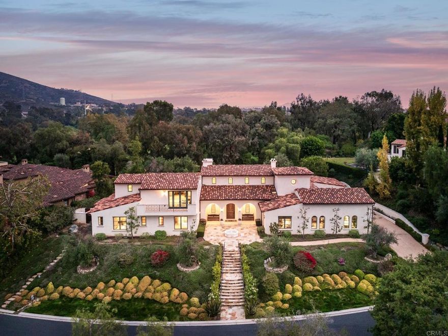 Discover the ideal family retreat tucked behind the prestigious gates of The Bridges at Rancho Santa Fe. Thoughtfully designed and meticulously crafted, this exceptional residence offers a light-filled, seamless layout complemented by premium, timeless finishes. Its modern Spanish architecture creates striking curb appeal, while the expansive great room welcomes you with volume, openness, and effortless indoor–outdoor flow.  The main level features the primary suite, three en-suite bedrooms, and a private office—providing comfort and convenience for everyday living. A full wall of sliding glass doors opens completely to showcase views of the sparkling pool, creating a perfect setting for year-round entertaining.  With five en-suite bedrooms, a spacious home office, two versatile flex rooms, and a bonus room, the home’s thoughtful design provides abundant space for family, guests, work, and play. The gourmet kitchen is equipped with commercial-grade appliances and an oversized island ideal for gathering. Adjacent to the kitchen, the elegant dining room is highlighted by a stunning climate-controlled wine wall—an impressive centerpiece sure to delight all who enter.