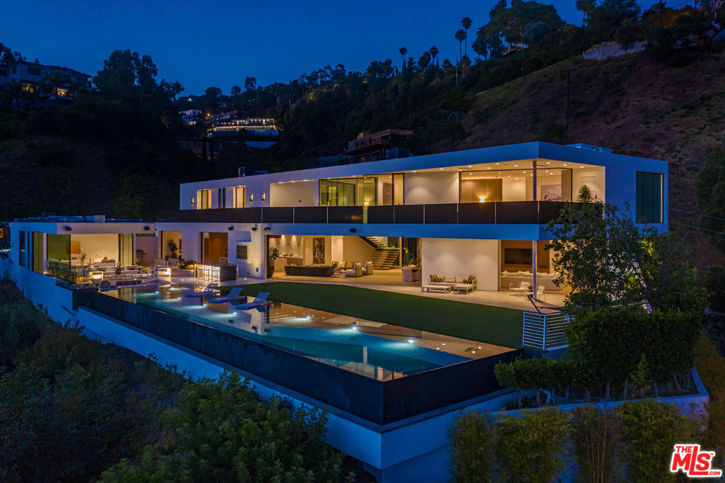 NEWLY PRICED! Rare opportunity to own a custom-built, design-forward masterpiece sited on a private knoll in coveted Beverly Hills. The pinnacle of indoor/outdoor living, this trophy residence boasts an inviting 10,700sf open floor plan, soaring ceilings encourage exploration and abundant picture windows/pocket glass partitions overlooking the city-to-sea vistas. Satisfy your appetite for culinary creation in the chef's kitchen. Host elegant gatherings where guests relax on the Baja shelf amid a 100ft saltwater infinity pool and huddle around the sunken fire pit when the coastal breeze sets in. 5-star amenities abound, 3 powder rooms w/integrated stone sinks and LED mirrors, office w/walnut shelves, laundry room w/top-of-the-line appliances, 300 bottle wine cellar, 500sf home theater, 6600sf delicately landscaped motor court, 5 tankless water heaters and 5 AC systems. 16 security cameras and Crestron smart-home tech w/built-in controls, for max privacy aligned w/the modern aesthetics.