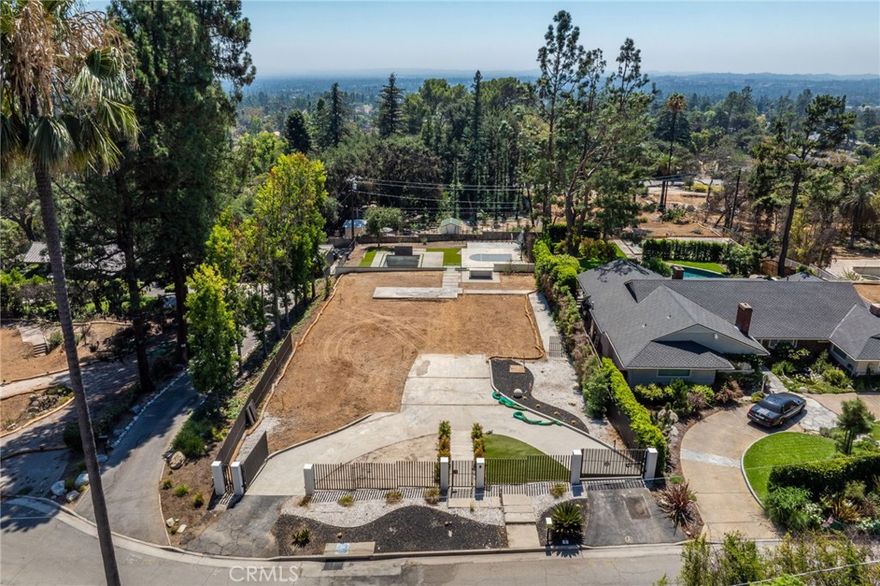 Beautiful lot in Altadena – prime opportunity to rebuild or build your dream home. Approved plans included!



Discover a rare and exciting opportunity to create your dream estate in a prime location in Altadena.  This expansive flat 20,000+ sq ft estate lot, nestled at the end of a quiet cul-de-sac, once housed a 4,200 sq ft.,  5 bedroom 5 bathroom beautiful home lost in the Eaton Fire—but the resort-style amenities remain intact. 



Enjoy the luxury of existing hardscaping, artificial turf, landscaping, gated circular driveway, built-in outdoor kitchen/BBQ, private sports court (basketball/pickleball), and a pool & spa—all just less than two years old. These existing amenities alone will save you hundreds of thousands of dollars on the rebuild. The lot is fully equipped with a newer septic system, and all utilities (water, electricity, and gas) were in place prior to the fire.

Located in close proximity from the Altadena Town & Country Club, this lot comes with recently approved architectural plans (2023 construction) saving you time and money on your rebuild.  Imagine a modern architectural masterpiece with walls of glass, open-concept living, and seamless indoor-outdoor flow—all designed to showcase breathtaking mountain views.



Key Features:



Over 20,000 sq ft flat estate lot

Approved architectural plans included

Existing pool & spa, outdoor bar, sports court (Basketball and Pickleball)

Artificial turf, landscaping, gated circular driveway & hardscaping

Septic system in place (2 years old)

All prior utilities available: water, gas, electricity, sewer

Debris removal completed (Army Corps Phase 1 & 2)

Located in a peaceful cul-de-sac near Altadena Country Club

Whether you're building your forever home or developing an investment property, this property offers a blank canvas in a coveted Altadena neighborhood. With approved plans and premium amenities already in place, you can move forward with confidence and vision.



Buyer to verify development potential, zoning, lot size, utilities, and permitting with Los Angeles County.