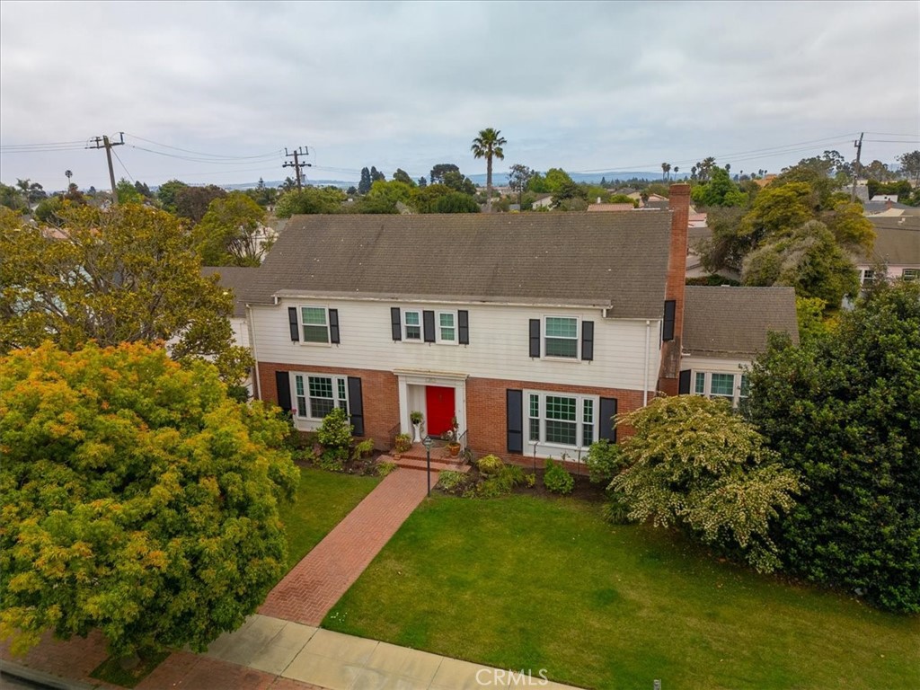 Nestled among the picturesque, tree-lined streets of the Carriage District, this beautifully maintained Colonial-style home is a rare find; set on 2 full size lots & brimming w/character, space & thoughtful upgrades. From its classic white exterior w/a striking red front door to its elegant, covered breezeway that connects the LAUNDRY ROOM & main home w/sep MUD ROOM & the garage. Step inside the Grand Foyer, where a wide staircase leads up to 2 generous upstairs BEDRM SUITES. This home is the epitome of style, grace & comfort mixed w/functionality. There is a LARGE FORMAL LIVING RM w/FP & an ELEGANT DINING RM for formal dinners or parties. A remnant of another time is the BUTLER’S PANTRY complete w/a bar area, sink & a BOSCH dishwasher -great for after a party! The GOURMET KITCHEN is a chef’s dream, featuring 2 full-size ovens, WOLF 5-burner gas range, a SUB-ZERO refrigerator & a 2nd dishwasher. There is an abundance of cabinets throughout the kitchen & FAMILY DINING AREA. This space can comfortably seat 6-8 & opens to the warm, inviting FAMILY RM w/custom raised hearth FP & backyard access -perfect for gatherings, game nights or quiet evenings at home. There is even a LIBRARY/office plus a rare BASEMENT! The luxurious PRIMARY SUITE offers a spa-like retreat w/its remodeled bath, 2 sep vanities, a spacious 2-headed shower, granite counters, travertine tile & an adjacent walk-in closet & direct access to the balcony overlooking the lush yard & an orchard w/fruit trees or build an ADU unit (ck w/the city for requirements). The Guest Suite features direct access to the balcony & a redone bathroom w/custom tilework. Downstairs, a 3rd BEDRM SUITE awaits w/a custom-remodeled bath, featuring an expanded custom-tiled shower w/3 sep showerheads, custom glass doors & a vessel sink. Sliding glass doors lead to a covered brick patio where you can relax or soak up the sun on the expansive patio beyond. The Library and the formal Living Room also have direct access to this space, which is perfect for coffee overlooking the wisteria-covered pavilion or dinner on a warm summer evening. Upgraded electrical w/a new 200/225 AMP panel & solar system. This home, on one of the largest lots in the Carriage District, is the perfect blend of classic elegance & modern convenience, offering room to grow, entertain & create memories. Homes like this rarely come to market - don’t miss your opportunity to own a true gem in one of the area’s most sought-after neighborhoods.