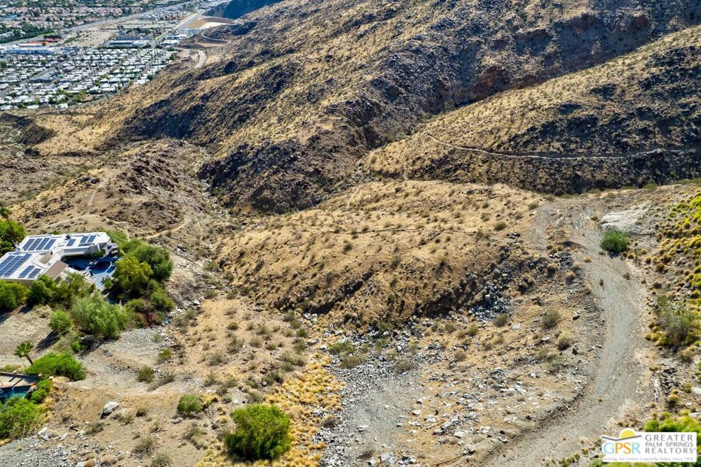 A rare opportunity awaits behind the gates of iconic Southridge, Palm Springs' most exclusive hillside community. Perched high in the San Jacinto Hills, this property offers commanding views of the desert floor and city lights below. Available for the first time in over 45 years, the site presents possibilities to create a world-class private estate on the expansive lot or explore the option to subdivide and build two exceptional residences. Southridge has long been home to some of Palm Springs' most celebrated architectural treasures and legendary residents. Just moments away are the renowned Bob Hope House designed by John Lautner, the striking Elrod House, as well as the personal residences of Steve McQueen and Hollywood icon William Holden, a masterpiece by Hugh Kaptur. For those seeking privacy, history, and the opportunity to shape a remarkable architectural legacy, this property delivers a truly once-in-a-lifetime chance to own in one of Palm Springs' most storied enclaves.