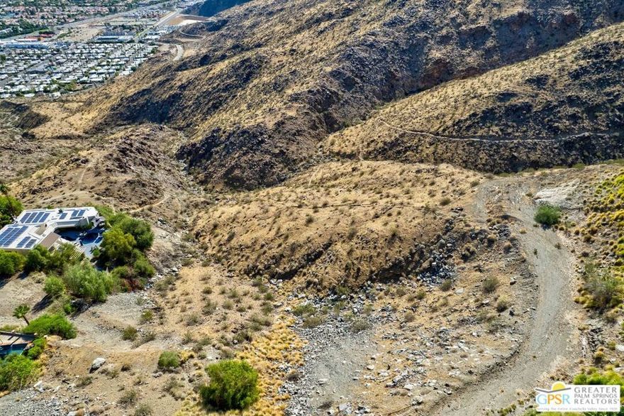 A rare opportunity awaits behind the gates of iconic Southridge, Palm Springs' most exclusive hillside community. Perched high in the San Jacinto Hills, this property offers commanding views of the desert floor and city lights below. Available for the first time in over 45 years, the site presents possibilities to create a world-class private estate on the expansive lot or explore the option to subdivide and build two exceptional residences. Southridge has long been home to some of Palm Springs' most celebrated architectural treasures and legendary residents. Just moments away are the renowned Bob Hope House designed by John Lautner, the striking Elrod House, as well as the personal residences of Steve McQueen and Hollywood icon William Holden, a masterpiece by Hugh Kaptur. For those seeking privacy, history, and the opportunity to shape a remarkable architectural legacy, this property delivers a truly once-in-a-lifetime chance to own in one of Palm Springs' most storied enclaves.
