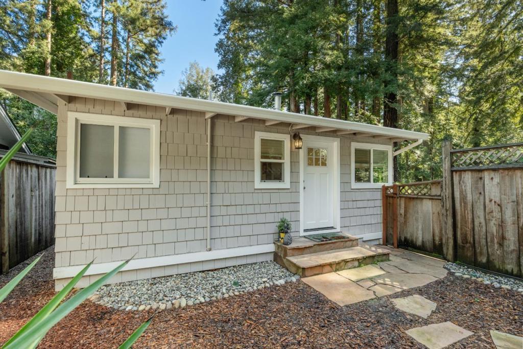 Breathe deep, mountain lovers! This single-level sanctuary is your escape hatch, nestled on a sun-drenched slice of Ben Lomond. Imagine mornings bathed in golden light, vaulted ceilings creating a sense of spacious calm, and a garden patio perfect for mindful moments. But don't let the tranquility fool you, this home's got a modern pulse. A 2010 refresh and a 2024 tech infusion, featuring a Tesla battery, EV charger and two brand new mini split heaters/AC, mean you're plugged into the future. Plus, parking for up to five vehicles, possible RV and maybe even add a carport or garage? That's amazing! Downtown Ben Lomond's charming cafes and shops are just a stroll away, while the majestic redwoods of Big Basin and Henry Cowell State Parks beckon for outdoor adventures. Need a city fix? Silicon Valley's a smooth 40-minute cruise, and Santa Cruz beaches are a breezy 25-minute jaunt. It's the perfect blend of mountain serenity and modern convenience. Come experience the calm.