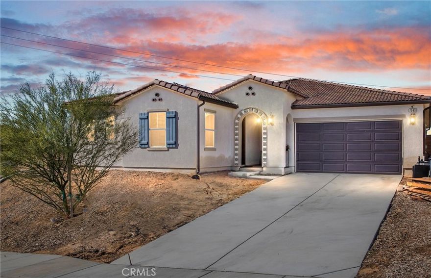 This single-story home, built in 2022 and nestled in the sought-after Spring Mountain Ranch Community, seamlessly blends comfort and style throughout.The kitchen is a dream, featuring stunning quartz countertops, sleek stainless steel appliances, a walk-in pantry, and a large center island with bar seating. Expansive windows at the back of the house invite natural light in and offer views of the backyard and outdoor living area. This residence includes four generously sized bedrooms and three beautifully appointed bathrooms. The fourth bedroom serves as a junior suite, complete with a kitchenette, mini bar refrigerator, walk-in closet, full bath, and its own entrance—ideal for guests, multi-generational living, or potential rental income. The spacious primary suite serves as a tranquil escape, featuring a bathroom with dual sinks, a separate walk-in shower, and a soaking tub. The covered patio is perfect for outdoor dining and gatherings. The backyard is private, with no rear neighbors, and offers a serene space to unwind and take in the breathtaking sunsets.Additionally, the home is equipped with solar panels for improved energy efficiency and savings. The community itself features a six-acre park and six miles of walking trails, all without a homeowners association. Conveniently located with easy access to the 215, 60, 10, and 91 freeways, this property provides a retreat-like atmosphere while being just minutes away from UC Riverside, Loma Linda Hospital, and shopping options.
