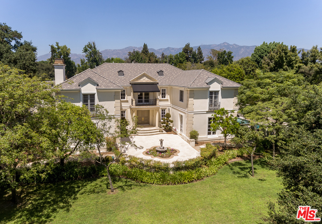 This elegant, French-style Pasadena estate pairs contemporary comforts with classic details. Perfectly situated moments from the Huntington Library, Art Collections and Gardens, the 8,322-square-foot residence was designed to accommodate both large-scale entertaining and day-to-day living. Through the gated entry and past the 3-car garage, find the front courtyard surrounded by lush foliage. Double doors open to reveal the 5-bedroom, 8-bathroom, 2-story home's interiors, which are replete with chateau-inspired details-from crown moldings and hardwood floors to ceiling alcoves adorned with chandeliers. Arched doorways provide seamless transitions from room to room. The updated kitchen boasts an eat-in island and wine fridge. Outside, find a lap pool, spa, tennis court and a covered outdoor kitchen ideal for gatherings. In addition to being near the Huntington, this estate is also located minutes from Old Town Pasadena and Downtown Los Angeles.