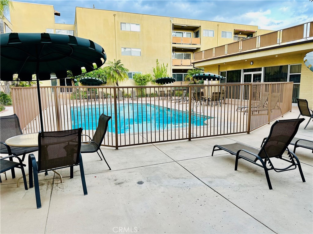 Direct access from your covered carport makes life easy—no stairs, no elevators, just walk right into your home. This updated 2 bed, 2 bath ground-floor condo features a rare, oversized private patio with blooming roses, an orange tree, and room to create your own outdoor retreat. Bright and airy with sliding doors off both the living room and primary suite, plus a renovated kitchen and bathrooms, a walk-in closet, and ensuite bath. All offers welcome—seller is open to a credit for wallpaper or cosmetic updates. Enjoy a sparkling pool and prime North Hollywood location with privacy, convenience, and outdoor space that’s hard to find.
