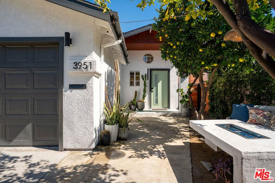 Situated in the vibrant heart of Atwater Village, this 4-bedroom, 3-bath residence showcases a refined contemporary aesthetic with thoughtful updates throughout. Inside, soaring ceilings and abundant natural light create an airy, open flow between the living, dining, and kitchen spaces. Custom wood shelving, a sleek fireplace, and curated lighting define the space with understated sophistication, while the newly designed kitchen serves as the home's center piece anchored by a large island with fluted wood detailing, dramatic veined quartz counters, and warm brass accents that add depth and character. The kitchen flows effortlessly into the family room and opens to the lush yard for seamless indoor-outdoor living. Four spacious bedrooms include two ensuite retreats offering peaceful comfort and curated details, while the yard complete with mature citrus trees, a fountain, and multiple entertaining areas creates a private oasis perfect for relaxing or hosting gatherings. Just moments from Atwater's favorite cafes, boutiques, and bike paths, this home captures the essence of modern Los Angeles living.