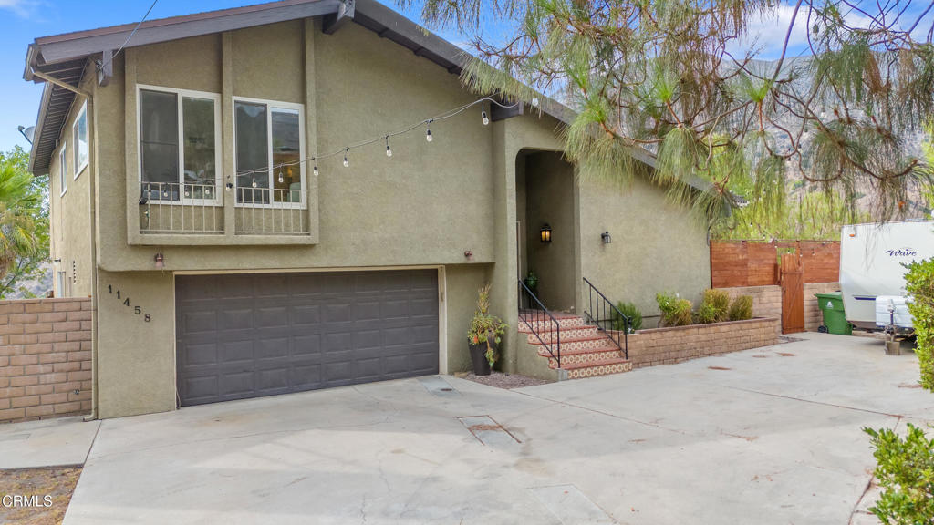Tucked away in the exclusive Alpine Village neighborhood of Tujunga, this home offer s breathtaking views and the feeling of a private retreat. Step inside to an open and spacious floor plan drenched in natural light. The large living room and dedicated dining area seamlessly connect to the chef's kitchen, highlighted by a massive center island that doubles as both a functional cooking space and a central gathering spot. The expansive primary en suite bedroom features a generous walk-in closet and provides the perfect sanctuary to unwind at the end of the day. Three additional bedrooms, anchored by a centrally located bathroom, offer ample space for family or guests. A large family room, complete with a wet bar and an additional bathroom, opens directly to the outdoors, an ideal flex space that can serve as a pool house, second living area, office, or guest quarters. The home's effortless indoor/outdoor flow extends to the stunning rear yard, where a shimmering pool, multiple lounging areas, and sweeping views set the stage for both relaxation and entertaining. Each evening brings a new, awe-inspiring sunset that feels like a painting in motion. Additional features include a cul-de-sac location, RV parking, a two-car garage, and an expansive lot. With nearby hiking trails and easy access to the 210 freeway, this is truly a one-of-a-kind property that will be coveted by many.