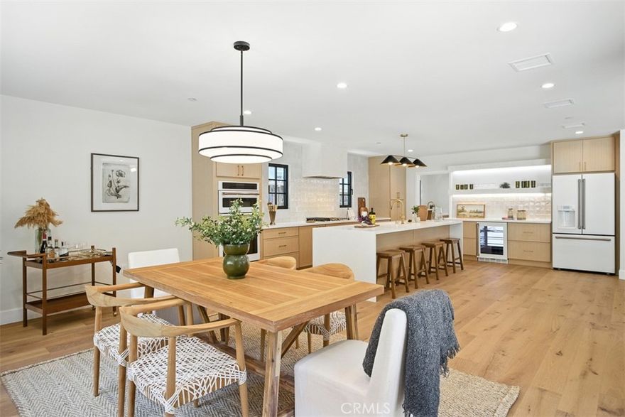 Refined Contemporary Living South of the Boulevard



Tucked away on a generous 12,600+ sq ft lot south of Ventura Boulevard, this fully reimagined 4-bedroom, 4-bathroom residence offers nearly 2,900 sq ft of elevated design and everyday livability. Every inch of the home has been thoughtfully curated, with warm engineered wood floors, designer tilework, and modern finishes that create a sense of effortless sophistication throughout.



The main level hosts three spacious bedrooms, each with access to a spa-like en suite bath. One opens directly onto a peaceful patio, while another—positioned at the front of the home—flows seamlessly to a charming covered porch, perfect for morning coffee or winding down at sunset.



At the heart of the home, the chef’s kitchen makes a bold statement, featuring a premium Café appliance suite, a striking counter-to-ceiling tile backsplash, custom under-shelf lighting, and a dramatic eat-in island built for both gathering and function. A walk-in pantry and dedicated laundry room add convenience without compromising style. The open-concept living and dining areas are anchored by a cozy fireplace and floor-to-ceiling windows that usher in natural light and offer direct access to the backyard—creating an ideal space for indoor-outdoor entertaining.



Upstairs, the primary suite feels like a boutique retreat, complete with vaulted ceilings, a private view balcony, a custom walk-in closet, and a spa-worthy en suite bath with dual floating vanities, a sculptural soaking tub, and a striking stone-clad shower.



Outside, the backyard is both intimate and expansive, with multiple zones for lounging, dining, and entertaining. A private staircase leads to a hillside lookout perch where sweeping canyon views stretch for miles—offering a serene backdrop that feels worlds away, yet remains just moments from the Shops at Sportsmen’s Lodge, top-rated schools, and the best of Ventura Boulevard.



This is Studio City living at its finest—where design, comfort, and location come together in perfect harmony.