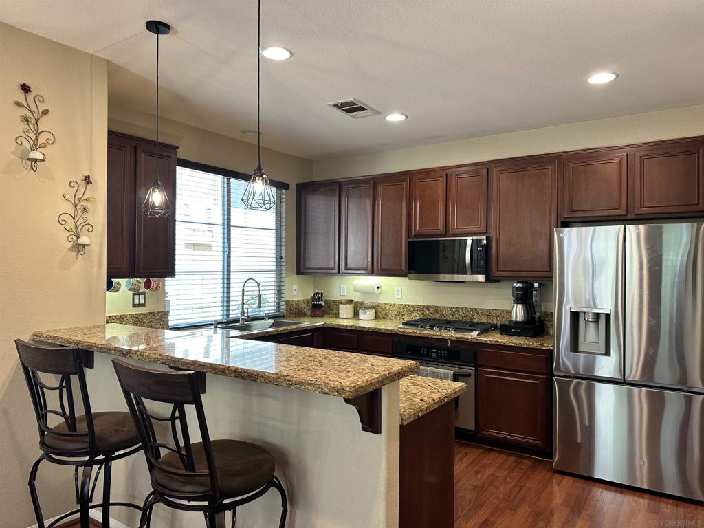 Situated in the foothills of Mount San Miguel in the NE corner of East Chula Vista this move in ready 2 story townhome is coming to market. Welcome to Belleza at San Miguel Ranch. Built in 2006 this 3bed/2.5 bath 1,372sqft home with direct access 2 car garage & private outdoor yard space is perfect to call home. Open floor plan includes a well sized kitchen with eat in bar that opens to the dining area & living room. Plenty of space to enjoy cooking your favorite meals with granite counters, SS appliances inc newer gas range/microwave, & single basin sink. Living room features fireplace, surround sound wiring, & faux wood blinds. Dining area flows into the low maintenance outdoor space perfect to enjoy year round SoCal living ready for outdoor dining. Powder room on 1st floor for guests. Primary bedroom features ensuite bath inc dual sinks, walk in shower, & private toilet area. All 3 bedrooms are upstairs on the same floor & all have ceiling fans. Laundry room w/sink. Dual pane windows, central heat & A/C with smart thermostat, Tesla electric car charger, MyQ smart garage door opener/keypad, video doorbell, & Yale smartlock keyless entry. Belleza amenities inc playground & picnic area w/BBQ which is in close proximity to unit. Pet friendly complex. FHA/VA approved. Only 3 units per building. Plenty of guest parking spaces w/2 guest passes. Home sits within the San Miguel Ranch community that provides a place to enjoy the pool, spa, water splash zone, gym, outdoor space, tot lot, tennis court, basketball court, clubhouse w/kitchen that can be booked for events just in time to start making your summer memories. Local schools inc Liberty Elem, Eastlake Middle, & Eastlake HS. Short distance to Mother Miguel Mtn Trail HD with pano views, Mt San Miguel park & dog park that provides an expansive almost 20 acres of winding trails, open green spaces, rentable gazebos, ball field, sports courts & more. The Shops @ San Miguel Ranch, Otay Ranch Mall, & all that East Chula Vista has to offer provides a well planned master community to thrive in providing for local shopping, great schools, recreation, & entertainment nearby. Easy accessibility to 125, 54 & 805 fwys.
