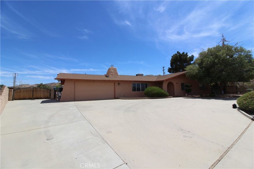 Welcome to your desert oasis in the highly-desirable Sky Harbor community, minutes from Joshua Tree National Park. This sprawling paradise is situated on an 18,295 SF lot complete with a solar-heated pool with waterfall, in-ground spa, built-in BBQ, circle driveway, and paved RV / boat parking. Inside you'll find new porcelain floors throughout, a fireplace in large entry room, and a remodeled kitchen with new countertops, stainless steel appliances, and abundant cabinet / counter space. The spacious master bedroom has an upgraded master bathroom with granite tile, a jetted tub, separate shower, and custom granite countertops.  This location is also prime, only minutes away from essential amenities, shopping, schools, hiking, and more. Plus, excellent opportunity for military housing, close to 29 Palms Marine Base.