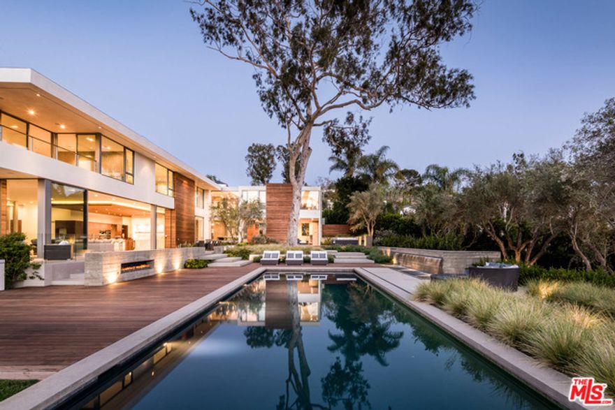 This brand new 13,777-sq.ft. architectural triumph from Gunderson Matkins, in collaboration with O+ L building projects, is sited on a rare, flat near-acre property in the Riviera section of the Palisades. Soaring walls of glass frame sweeping canyon views while walnut floors and board-form concrete provide a canvas for the quintessential California lifestyle. A spectacular 1,750-sf master suite positioned for optimal privacy and ocean views includes dual bathrooms and closets with a 3-story elevator to a seasonal wardrobe. Years in the making, the home features 4 additional en-suite bedrooms, chef's kitchen, butler's kitchen, formal living & dining rooms, family room, library, home theater, safe room, wellness studio with sauna, wine cellar, staff quarters, 2-bd guest villa and 7-car garage plus carport. A 50' pool with spa, Bocce court, level lawn and multiple entertaining terraces complete this inimitable offering. Equestrian and stable-ready with direct access to Will Rogers SP.