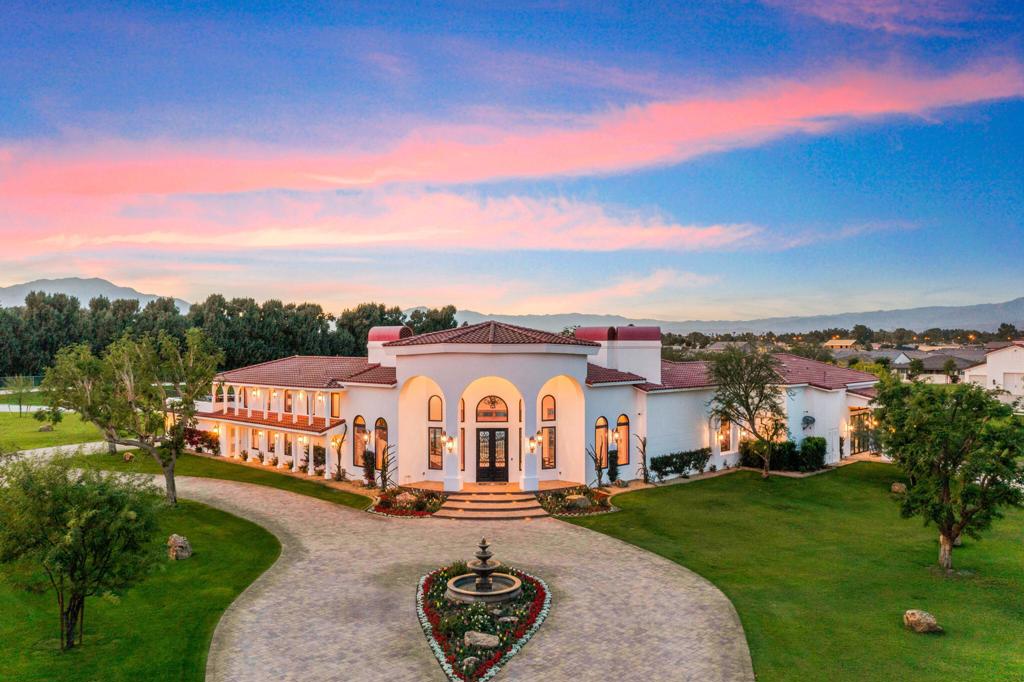 The Zenda Equestrian Estate is a truly unique offering with endless possibilities. Ultra-secure with one guarded gated entrance and two electric gates, the estate sits nearly ten acres, fully fenced in amongst a small enclave of estates homes. Breath-taking 180 mountain views, with close proximity to the famed Coachella music festival, Empire and Eldorado Polo Club, Thermal Airport, and The Thermal club for the race car enthusiast. Recently completed in 2019, The main house offers approximately just over sixty-five hundred sq feet of living space, four bedrooms, and seamless indoor and outdoor living--a one bedroom, detached guest house with a spacious living room, kitchen, laundry, and garage. The residential barn structure showcases massive vaulted ceilings and open space with a movie projection screen, projector, theater seating bathroom, shower. Enjoy the benefits of Solar that is owned outright, a well for the property grounds landscaping water. All structures are connected to city water and sewer. The Zenda Estate is contemporary in design, appealing to the most discerning buyers who appreciate impeccable quality and exquisite artisanship with privacy. This recently completed compound is a dream estate and a rare offering. This estate is not part of an HOA, and short-term rentals are permitted per the city of Indio. Buyers should contact the City of Indio to verify conditions and limitations.