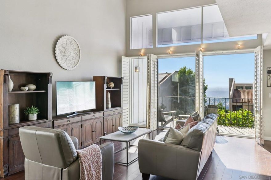 Nestled within the highly desirable gated community of Del Cerro Heights, this stunning home offers an unparalleled blend of comfort, style, and convenience. Step inside an open-concept living space where huge windows frame sunset and panoramic city views from the upper level, providing a breathtaking backdrop for both quiet relaxation and lively entertaining. The main level boasts distinct formal living and dining areas, and a private office/den with a cozy fireplace. A balcony adjoins the living room, perfect for taking in the views. The spacious kitchen is a chef's delight, featuring ample cabinet and countertop space. You'll find three generously sized bedrooms, including a serene primary suite with panoramic views and a large, completely remodeled bath offering dual sinks and a soaking tub. An updated guest bath completes the interior. Extending your living space outdoors is a private, low-maintenance patio, ideal for enjoying the beautiful San Diego weather. This home also includes a two-car garage with ample storage, plus an extra bonus storage room. Beyond your doorstep, the Del Cerro Heights community provides an array of top-notch amenities. Stay active with an Olympic-sized heated pool, tennis courts, and a well-equipped gym. Socialize at the clubhouse or enjoy family time at the park and playground. The prime location offers easy access to outdoor adventures at Lake Murray, Cowles Mountain, and the Mission Trails Golf Course. San Diego State University and Grossmont College are just minutes away. This Del Cerro Heights gem offers the best of San Diego living!