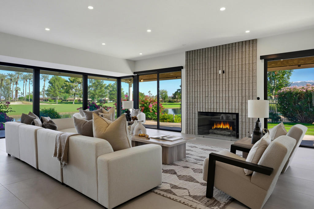 Experience elevated desert living in this stunning 3-bedroom, 3-bathroom, lakefront residence showcasing panoramic south and southwest views across the 1st and 2nd double fairways. Thoughtfully expanded and extensively remodeled in August 2025. The Shaughnessy floor plan has been transformed into a modern masterpiece where sophisticated design meets effortless indoor-outdoor living. A wall of glass wraps the morning room, kitchen, and living area, framing serene water and golf course vistas while flooding the home with natural light. The open-concept living space features 24''x48'' porcelain tile flooring throughout, a striking split-face concrete slab fireplace, and seamless transitions to the expansive outdoor patio--ideal for relaxing or entertaining against a breathtaking backdrop. The chef's kitchen is a true showpiece, boasting waterfall quartz countertops, custom soft-close cabinetry, and top-of-the-line KitchenAid appliances. Every detail was curated with luxury and functionality in mind, offering both a refined aesthetic and exceptional performance. Automatic Blinds are installed throughout the home. Each of the three spacious bedrooms offers comfort and privacy, with beautifully updated en-suite baths showcasing designer finishes and modern fixtures. The primary suite captures tranquil lake views and exudes understated elegance, while guest suites provide the perfect retreat for family and friends. Additional upgrades include two newer HVAC systems (installed 2 years ago), all-new ductwork, and a four-foot expansion off the living room, enhancing both comfort and livability. Perfectly positioned to capture morning light and glowing sunset skies, this home offers the best of golf course and waterfront living in one exquisite setting. Every inch reflects thoughtful craftsmanship and contemporary luxury--making this residence truly one of a kind. The Springs, it's where you belong!