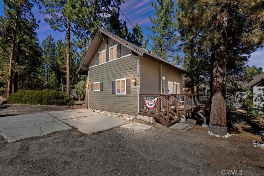 WELCOME TO YOUR DREAM HOME, FULLY FURNISHED AND READY TO MOVE IN! Just steps to Boulder Bay in beautiful Big Bear Lake. Offering 1134 sq ft of living space with central heating on a LARGE 14,000 sq ft lot. The owner spared no expense with beautiful upgrades and amenities. Newer roof, windows and French doors leading to wrap around porch with seating and BBQ, perfect for entertaining. This inviting 2 bedroom and 2 full bathroom mountain retreat is less than 5 minutes to Big Bear Lake and The Village. Walk into the open concept living area with a cozy fireplace and many games to enjoy. One full bathroom downstairs, two comfortable carpeted bedrooms upstairs with a full bath and dryer ready to heat your towels on those cold nights. Flat parking pad with ample parking right off the street for easy access to the front door. Ample storage under the home. Enjoy sledding down your own snow covered hill right from your porch. This home delivers on location, charm and comfort for all seasons. PRICED TO SELL!!! THIS ONE WON'T LAST LONG!!!