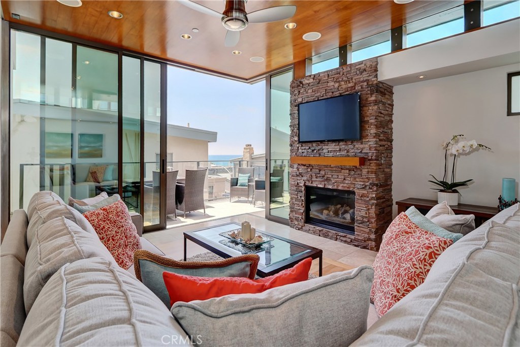 Located only three doors from the beach in highly coveted South Manhattan Beach, this sleek and sophisticated townhome offers the ultimate in coastal living. Nestled in the prestigious “Between the Piers” neighborhood, enjoy easy strolls to both downtown Manhattan Beach and Hermosa’s vibrant dining and shopping scenes.
Designed with dramatic architectural flair, the home welcomes you with a striking pivot door entry and a sculptural open staircase. Walls of retractable floor-to-ceiling glass blur the lines between indoors and out, framing panoramic ocean and whitewater views. Premium finishes abound—rich hardwood floors, artisan glass tile, and a state-of-the-art kitchen featuring stainless steel, top-tier appliances.
This home is as functional as it is beautiful, with a two-car tandem garage plus an additional covered carport for guests.
A rare opportunity to live in a modern coastal retreat in one of the South Bay’s most sought-after locations.