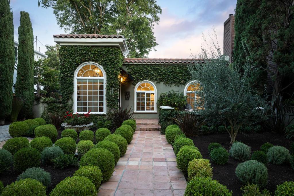 Nestled in the premium part of The Willows, this 4-bedroom, 2-bath Mediterranean-style home blends timeless character with fresh updates. Set on a beautifully manicured 7,000SF lot, that feels much larger, the property offers lush gardens visible from every window, a San Francisco cobblestone patio and driveway, Saltillo-tiled patios for entertaining, and a detached rear garage with alley access that can serve as an office or accessory dwelling unit (ADU). Inside, freshly refinished hardwood floors, new paint, and a split floor plan create bright, flexible living spaces. Around the corner from Haven Wine Bar, Café Zoë, a neighborhood grocery with authentic burritos in the back, and other local favorites, the home is walkable to both downtown Palo Alto and Menlo Park. Bike to Stanford University, Stanford Hospital, Burgess Park and Recreation Area, or the library. Conveniently closebut not too closeto major commuting corridors. With its abundant outdoor spaces, fairytale landscaping, and attractive architecture, this home perfectly balances style, comfort, and an enviable Menlo Park lifestyle.