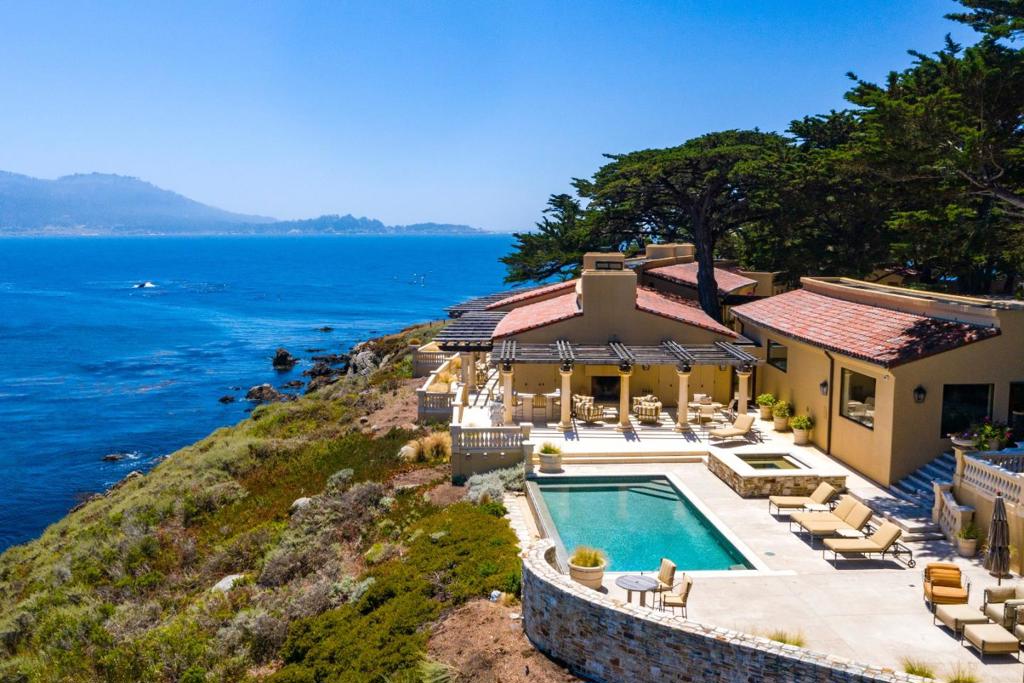 Privately situated on Pescadero Point and a short stroll to The Lodge, this landmark home is one of 31 rarely available water front properties in Pebble. This iconic Pebble Beach ocean front estate offers stunning views from every room of the Pebble Beach Golf Links, Carmel Bay and Beach, Carmel Valley and Point Lobos. Offering 4 ocean view suites, including an expansive master suite with sitting room/office, and a detached guest house, the gracious residence is bathed in natural light and also offers vaulted ceilings, open floorplan with spectacular kitchen, living and dining areas, ideal indoor-outdoor living and entertaining, with a grand informal family room leading out to an ocean side terrace, with kitchen and infinity swimming pool.