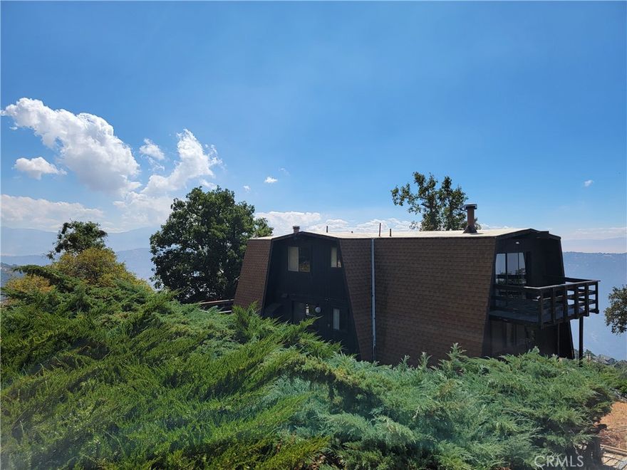 Sweeping panoramic views, from this beautifully situated home. Perched on a dramatic promontory above Bear Valley Springs, this lovely home features three bedrooms, 2 full baths, and 1,856 feet of living space, plus a huge wraparound deck. Nearly level entry from the maintained (and plowed) road, with a huge 2-car garage - easy in/out. The open high-ceiling living room reminds one of a European chalet, with vintage accents and retro Malm fireplace. Floor to ceiling windows for spectacular views of Bear Valley, and the San Joaquin Valley to the west. Two ample bedrooms on the main level, functional kitchen, and an old-school wet bar, full bath, laundry room. 34,000 BTU mini-split for cooling and heating. Upstairs features an open loft above the living room with its own amazing views, plus a primary bedroom with gorgeous Malm fireplace, and more views! Downstairs basement/build-up is nearly level, and could be turned into a rec room, or additional living space. Small upgrades will add instant equity, and opportunities to make this home shine even brighter. Furnishings may be included with strong offer, with some exceptions.



The lovely 2.3 acre lot features granite outcroppings, oak trees, pines, local flora, and lots of open space. This rustic original home finds a perfect balance of privacy and perspective, and must be seen to be appreciated. Feels like your own private mountain lair, with ever-changing California skies. You might see hawks flying above or below, majestic elk and deer, bears, bobcats, and mountain lions cruising through your wide views of the hillside and meadows below.



Secluded, yet close to town, the prestigious Bear Valley Springs Country Club gated community features a wide variety of amenities, including sports leagues, equestrian center, golf, pool, gym, shooting range, tennis/pickleball, rec center, restaurants, and much more. Add the lakes, camp sites, the nature trails, and historical preserves nearby - including the 72,000 acre Randall Preserve. The town of Tehachapi is a quick drive, and has all the shopping and dining options you'll need for comfortable mountain living, or spectacular vacations in the Southern Sierra.