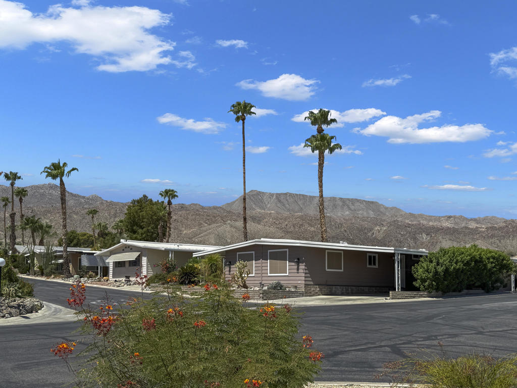 Views /Views/Views/One of the Best locations in the park on a large corner lot with magnificent mountain views and a greenbelt setting inside the gates of Indian Springs Senior +Park. Close to the clubhouse and pool. Front & side patios with fountain, plus lemon, grapefruit, and tangerine trees. Wide open floor plan with large living room, dining and den areas. Updated painted interior with wood blinds and ceiling fans, ceramic tile in kitchen & entry. New counters, hardware, gas stove with griddle, double ovens. Extra large master bedroom with built-ins & mirrored closets. A new FAU and 4 ton AC Condenser were installed in 2018 and regularly serviced by Hydes.this property is located close to the world famous El Paseo village for fine dining shopping and entertainment. Must see to appreciate. Clean & ready to move in.Hurry this wont last longSPC Rent 763.15 per mos