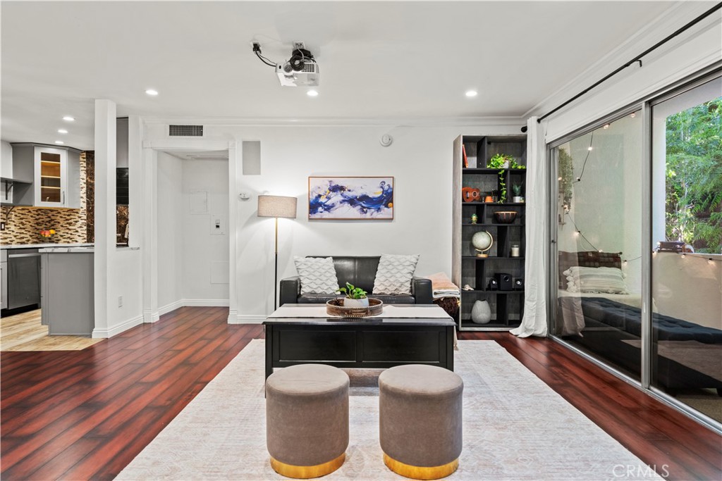 Welcome to this stunning, remodeled end-unit that boasts a split-wing floor plan with 2 primary suites, 2 updated en-suite bathrooms, dedicated parking, garage storage, and an IN-UNIT COMBO WASHER/DRYER UNIT! Enter through the double-door entry into this immaculate unit with a large living room that's designed for entertaining complete with recessed lights and a CEILING PROJECTOR and BUILT-IN SURROUND SOUND SYSTEM providing a true movie-like experience. Your custom-designed kitchen features stunning porcelain countertops, mosaic tile backsplash, modern shaker style soft-close cabinetry with two Lazy Susans and a pull-out spice rack, stainless steel appliances, recessed lighting, and Italian-tiled flooring. Natural light pours in through the large windows of both bedrooms which offer privacy being set on opposite ends. One side features a walk-in closet, office desk area, and a bathroom that screams modern elegance boasting a double-sink vanity with granite countertops, floating shelves, and a drop-in bathtub adorned with beautiful tiled walls and floors. The other suite includes a wall-mounted TV, a bathroom featuring an updated vanity with granite countertops, and a walk-in shower with a bench seat, frameless sliding shower doors, and beautiful tiled walls. Your private living room balcony offers peace and tranquility behind beautiful trees while you get to enjoy your morning coffee or calm evenings while listening to birdsong and nature. Your controlled-access building features a formal lobby, secured parking garage with dedicated parking, elevator, common area laundry, and an HOA includes a pool, BBQ area, water, gas, and trash. Located close to multiple parks, eateries, shops, and entertainment options within the Encino Commons and Ventura Blvd with easy access to major freeways (101, 405, Metro Busway) what more could you ask for! Don’t miss this exceptional opportunity to own a move-in ready condo with all the modern conveniences and a prime location!