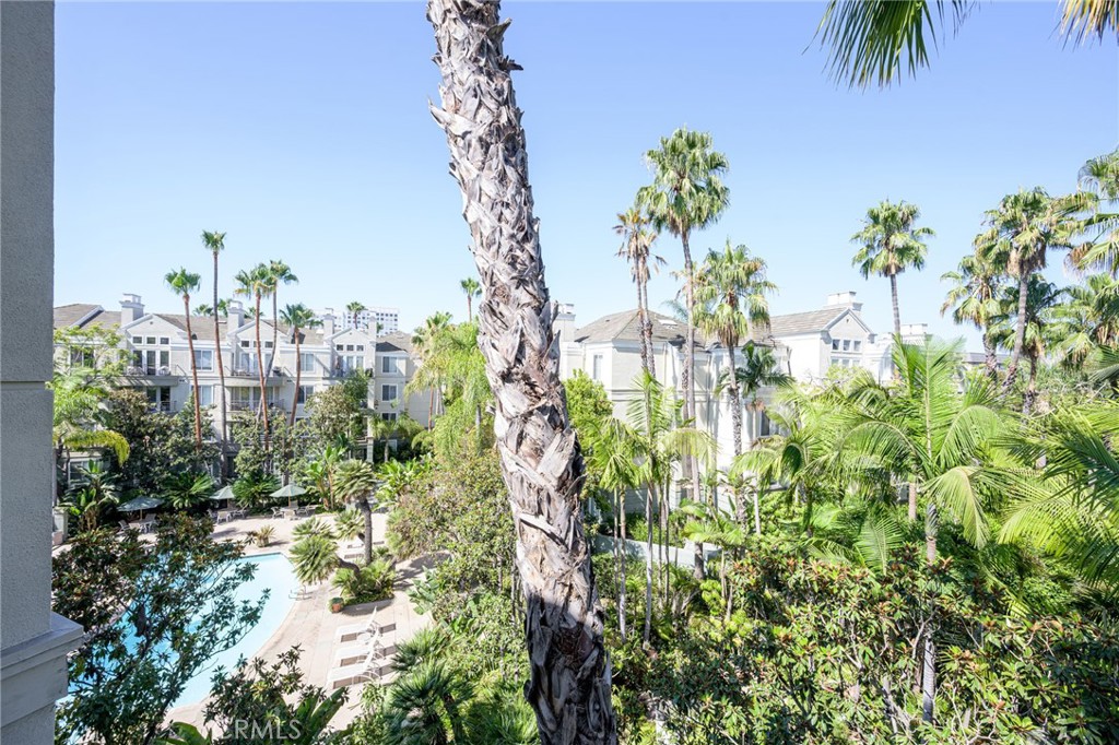 SPECTACULAR PENTHOUSE, Views of palm trees, pool and spa from high above! Boasting a spacious floor plan in the highly desirable Metropolitan, this model perfect residence features two master suites, formal entry with wall-mirror, large living room with vaulted ceilings & fireplace with custom mantle, formal dining area with designer light fixture and floor-to-ceiling wall mirror. Spacious kitchen opens up to the living area, and boasts ceramic tile floors, upgraded appliances, recessed lighting, breakfast nook and raised breakfast bar. Also of note is an inside laundry area with washer & dryer included. Dual master suites; first one with French door access to the deck, walk-in closet with mirrored closet doors, and large master bathroom with upgraded floors, large vanity with dual sinks, skylight and Roman soaking tub. Spacious second master suite with walk-in closet and bathroom with dual vanities & skylight. Upgrades include brand new designer carpeting, fresh two-tone interior paint, extensive use of custom baseboards & crown molding, plantation shutters & more. Private deck with views of pool, spa & palm trees, and penthouse location. Subterranean 2 parking spaces side by side. Centrally located close to South Coast Plaza, Fashion Island, beaches, freeways 405, 73, 55, and John Wayne airport. A must-see!!!