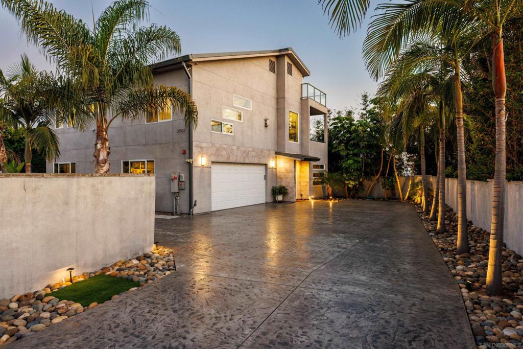 Custom-built contemporary masterpiece in the historic Loma Alta neighborhood with INCREDIBLE VIEWS. Just 2 miles from the beach and walking distance to Buddy Todd Park. Completed in December 2017, this 3,435sqft luxury home was thoughtfully designed to capture panoramic ocean and mountain views from every level. Owned Solar & EV charging, dual Zoned AC, tankless water heater & metal roof. The entry-level offers two spacious bedrooms, a large Jack-and-Jill bathroom, kitchenette, and family room with French doors leading to a lush, low-maintenance backyard featuring synthetic turf and a 1,000-gallon rainwater storage system. Upstairs, the open-concept main living area boasts soaring 10’ ceilings, a chef’s kitchen with waterfall-edge quartz island, KitchenAid stainless appliances, walk-in pantry, and beverage station. The living room includes a linear gas fireplace and a 13’ panoramic glass wall system that opens to a covered lanai with sweeping views. The luxurious primary suite features a freestanding tub, dual vanities, walk-in closets, and ocean-view deck access. Additional highlights include an 871sqft rooftop deck with a glass wall for unobstructed views of the ocean and mountains! A gated driveway, oversized 4-car garage with epoxy floors, bonus half-bath, and extra laundry hookups. High-efficiency HVAC, central vacuum, premium finishes, fire sprinklers, and upgraded structural elements provide both comfort and safety. Easily adaptable for a 4th bedroom. Truly a rare opportunity to own a one-of-a-kind modern coastal home.