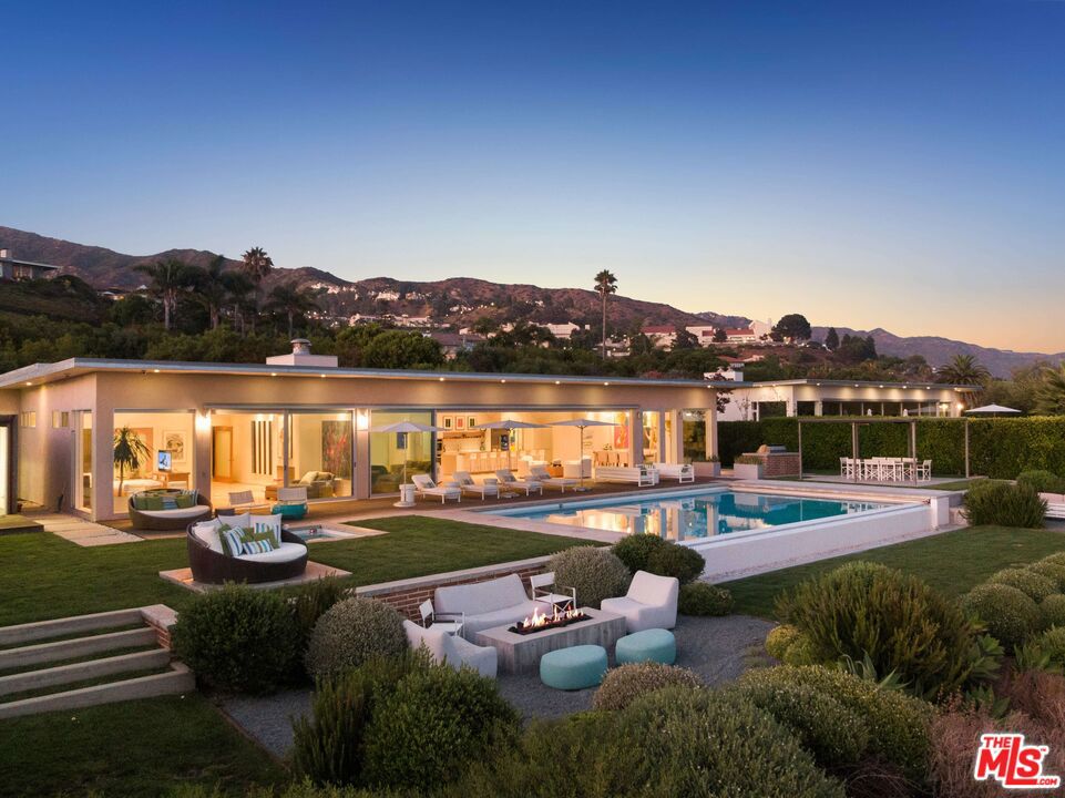 This private contemporary compound is designed as a serene sanctuary minutes from the Malibu Country Mart, Cross Creek, Nobu, Soho Beach house, and world class beaches. As one of four estates in a gated bluff top enclave known as THE WHO, offering panoramic ocean vistas and quintessential Malibu sunsets, this architectural is the ultimate statement of the health and wellness spa environment. From Art Collectors wishing to showcase extraordinary collections to those looking for the ultimate retreat the main house delivers on a single floor with a magnificent great room, primary suite on oceanside, an additional four spacious bedroom suites, and a lower media room. Additional out buildings include an extra guest bedroom suite/art studio/office, a garage, and an exercise pavilion outfitted to be an extraordinary gym or meditation and yoga destination with adjacent spa. A full outdoor Al Fresca kitchen and dining cabana complete this oasis. Curated design elements created originally by Scott Gillen/Unvarnished include 13' exposed wood beam ceilings, walls of Fleetwood glass doors that open to the long infinity edge pool, white oak wood floors throughout, and a custom Bulthaup kitchen.