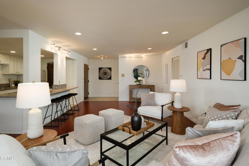 Welcome to this turnkey end-unit condo in the desirable Casa Ricardo building, located near Madison Heights in Pasadena. Upon entering you'll find an open floor plan bathed in natural light, complemented by sleek flooring & recessed lighting throughout. The spacious living area extends to a private balcony, perfect for relaxing or entertaining. The adjoining dining area flows seamlessly into the modern kitchen, which features granite countertops, a central island with bar seating & a gas cooktop. A white refrigerator, oven & dishwasher, complete this well-designed space. A convenient storage closet is located near the front entrance, providing ample space for coats & shoes. Down the hall, the first bedroom is generously sized, offering recessed lighting & a spacious closet. Across the hall is a beautifully updated bathroom, showcasing a frameless glass shower enclosure with marble-tiled walls, dual sink vanity with quartz countertops & modern fixtures. The spacious primary suite offers a peaceful retreat, featuring recessed lighting, a large walk-in closet & built-in cabinets for additional storage. The attached ensuite bathroom is complete with a marble-tiled tub & shower combination & a dual sink vanity with quartz countertops. This secure building offers a gated lobby & elevator access for added convenience & peace of mind. Centrally located, you're just moments away from the South Lake District, Old Town Pasadena, CalTech & the Metro Gold Line, making it the ideal place to enjoy all that Pasadena has to offer. Don't miss your chance to make this exceptional updated condo yours.