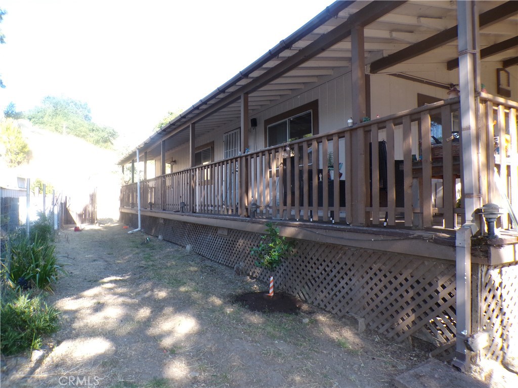 Sometimes in real estate certain homes just give off what we call that "vibe". It' a feeling that as soon as you walk up onto the porch you're home and you're comfortable. This quaint country home has that aura to it. The spacious wrap-a-around covered porch is surrounded by shade trees keeping the home cool. The front yard has a fenced in area which is perfect for gardening or giving pets a place to roam. Inside the home we have an open floor plan which makes the front room seem HUGE! The kitchen is spaced out well with plenty of cabinet/counter room. The bedrooms are large. The laundry room gives ample space for folding clothes. There is a built in office area. The carport/garage is large enough to park a boat in. Everything about this home is comfortable and functional. The location is in many ways perfect, close to schools, shopping and walking distance to the lake. If you're looking for a fantastic starter home then you can't go wrong taking a look at what this extremely comfortable family home has to offer.