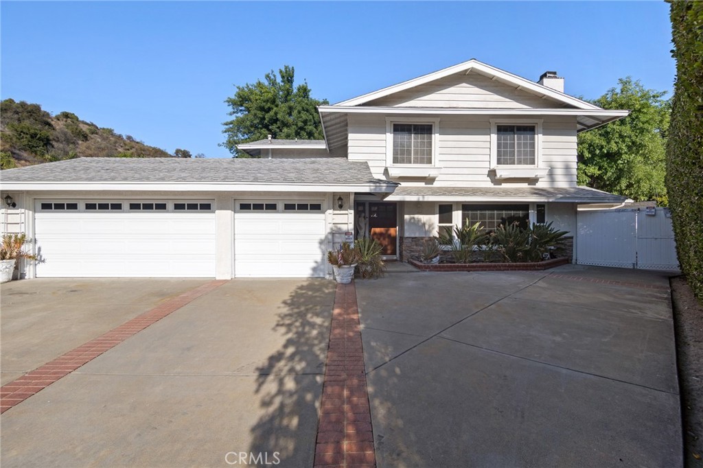Welcome to 23900 Darbun Drive – a beautifully maintained 5-bedroom, 3.5-bath home offering over 3,100 sqft of spacious living on a generous 15,297 sqft lot! This stunning residence blends comfort and functionality, featuring an open-concept layout perfect for modern living. The chef’s kitchen boasts a large center island, abundant cabinetry, and easy flow to the dining and living areas. A cozy fireplace anchors the main living room, creating a warm and inviting atmosphere. The spacious primary suite includes a private bath and ample closet space, while four additional bedrooms provide room for family, guests, or a home office. Outside, the expansive backyard offers endless possibilities for entertaining, gardening, or future upgrades, and features a delightful variety of fruit trees including orange, peach, apple, three lime, pomegranate, small tangerine, pear, apricot, guava, chirimoya, black grapes, green grapes, cherries, avocado, loquat, and persimmon. A 3-car garage provides ample parking and storage. Located in a peaceful neighborhood with a private feel, this home has everything you need and more.
