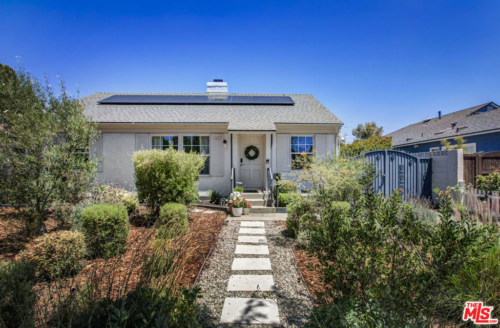 On a beautiful tree lined street, stands this classic 1950's traditional in the best pocket of Lake Balboa! Huge yard with tons of potential and walking distance to highly rated Stagg Elementary School. Light and bright interior with focal point fireplace in living room and original hardwood floors throughout. New roof, newer double paned windows and new garage door. Outdoor space includes a covered patio (recently screened!), large flat yard for future pool or ADU (or both) and two mature fig trees. Detached two car garage with spacious concrete pad in back for an extension or conversion. The seller has installed solar panels, upgraded electrical panel, installed newer kitchen appliances and updated front yard to drought tolerant landscaping. This home is full of charm and potential - don't miss out!
