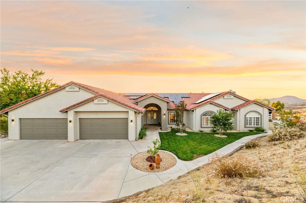 Discover unparalleled country living in Temecula’s prestigious Glen Oaks Community, nestled among tranquil rolling hills and award-winning wineries. This single-story estate, spanning 4.41 lush acres, offers 4 bedrooms, 3 bathrooms, an office, and 2,833 sq ft of refined living space. Enjoy stunning vistas of Temecula’s wine country, where hot air balloons drift across morning skies, creating breathtaking views.
Enter through a private automatic gate, along a short, panoramic driveway to your 4-car garage. The grand double-door entry leads to a luminous living room, bathed in natural light. The adjacent primary suite impresses with its vaulted ceilings, a walk-in closet, and a spa-like bathroom featuring dual sinks, a soaking tub, and a separate walk-in shower.
The heart of the home is the open-concept kitchen and family room. The gourmet kitchen dazzles with stainless steel appliances, a double oven, a walk-in pantry, and ample cabinetry. Expansive windows in the family room frame breathtaking winery views, infusing warmth and tranquility.
Outside, sip morning coffee on your private covered patio, captivated by hot air balloons floating over local vineyards. A gazebo, pool, and spa enhance the tranquil outdoor oasis. The estate’s 42 fully paid-off solar panels, generating 28.5 MWh in 2024, ensure energy efficiency, complemented by a 14-50 EV outlet in the garage and a Tuff Shed outside for all the toys. Perfect for a peaceful retreat or lucrative Airbnb, this estate blends sustainable solar power, luxury, and Temecula’s Wine Country charm.