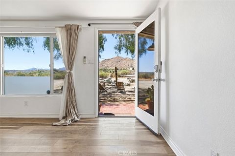 Photo of 10931 Mescalero Ave, Morongo Valley, CA 92256 (MLS # JT26083899)