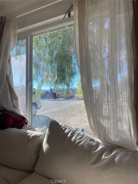 Photo of 10931 Mescalero Ave, Morongo Valley, CA 92256 (MLS # JT26083899)