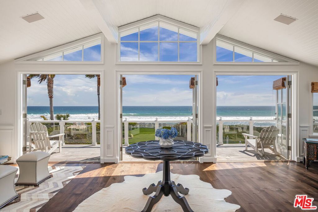 The Hamptons meets Malibu...Set along one of the most coveted stretches of Broad Beach Road, this exceptional coastal estate spans over 15,000 square feet of flat, beautifully landscaped grounds with expansive beach frontage. Inspired by the timeless charm of the Hamptons and the relaxed sophistication of Malibu, this compound captures the essence of elevated coastal living...effortless, elegant, and enduring. Privately gated and surrounded by mature landscaping, the main house offers four bedrooms and four bathrooms, complemented by a separate one-bedroom guesthouse with its own living area. Inside, the home has been thoughtfully reimagined with custom millwork, wide-plank oak floors, and a soft, coastal palette. Walls of glass disappear to reveal unobstructed ocean views and seamless access to an expansive beachfront grassy lawn and entertaining terrace.The home has been thoughtfully upgraded throughout, including all-new landscaping and hardscape, a reimagined chef's kitchen with premium appliances and modernized systems throughout the estate. Outside, a private spa and fire pit create an idyllic setting for intimate gatherings, while direct access to a rare sandy beach completes this extraordinary offering along Malibu's iconic coastline. Every element of the home has been curated for beauty, comfort, and effortless flow. Timeless, turnkey, and impeccably styled, this is coastal living at its finest.